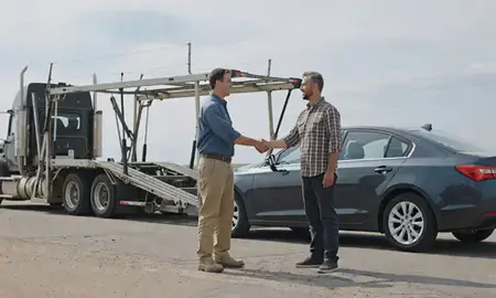 Vehicle owner beside their delivered car in Sidney, Nebraska, United States
