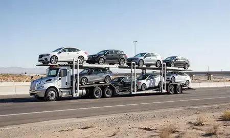 Multi-level car carrier on the highway to Enterprise, Nevada, United States