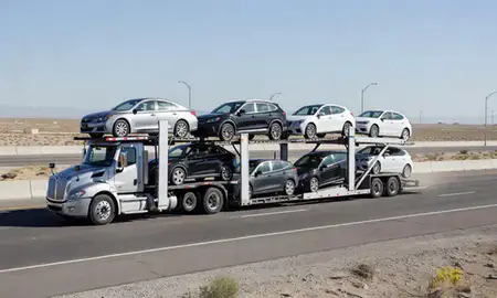 Multi-level car carrier on the highway to Johnson Lane, Nevada, United States