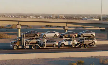 Car transporter with the Mesquite, Nevada, United States skyline behind it