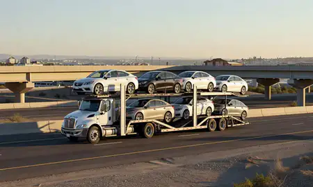 Car transporter with the Spanish Springs, Nevada, United States skyline behind it