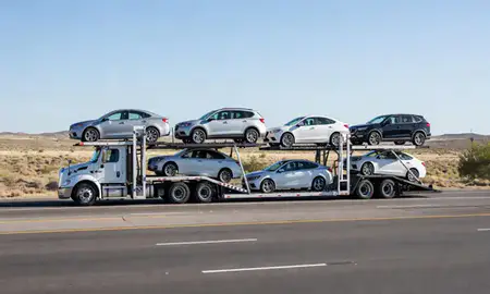 Multi-level car carrier on the highway to Spring Creek, Nevada, United States
