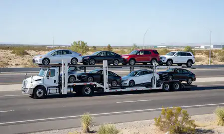 Multi-level car carrier on the highway to Whitney, Nevada, United States