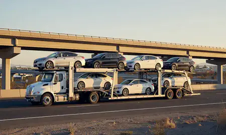 Car transporter with the Whitney, Nevada, United States skyline behind it