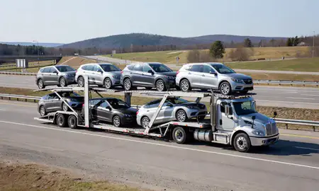 Multi-level car carrier on the highway to Berlin, New Hampshire, United States