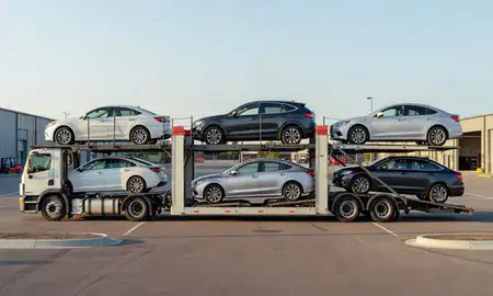 Car transporter parked in an industrial area of Claremont, New Hampshire, United States