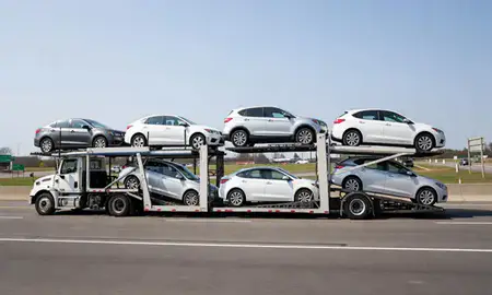 Multi-level car carrier on the highway to Concord, New Hampshire, United States