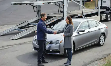Vehicle owner beside their delivered car in Concord, New Hampshire, United States