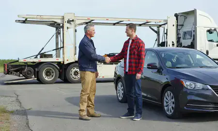 Vehicle owner beside their delivered car in Contoocook, New Hampshire, United States