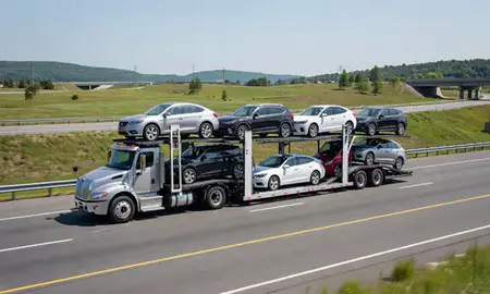 Multi-level car carrier on the highway to Groveton, New Hampshire, United States