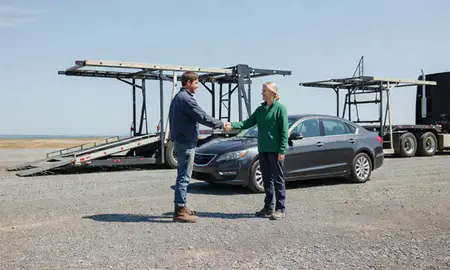 Vehicle owner beside their delivered car in Klondike Corner, New Hampshire, United States