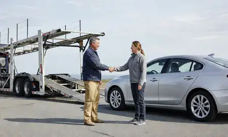 Vehicle owner beside their delivered car in Laconia, New Hampshire, United States