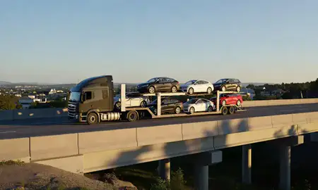 Car transporter with the North Conway, New Hampshire, United States skyline behind it