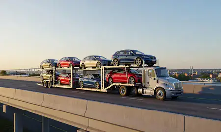 Car transporter with the Portsmouth, New Hampshire, United States skyline behind it