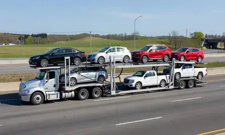 Multi-level car carrier on the highway to Rochester, New Hampshire, United States