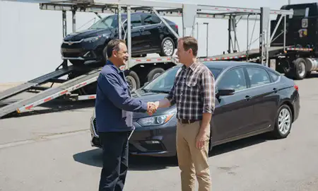 Vehicle owner beside their delivered car in Suncook, New Hampshire, United States