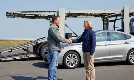 Vehicle owner beside their delivered car in Tilton Northfield, New Hampshire, United States