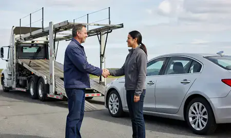 Vehicle owner beside their delivered car in Woodsville, New Hampshire, United States