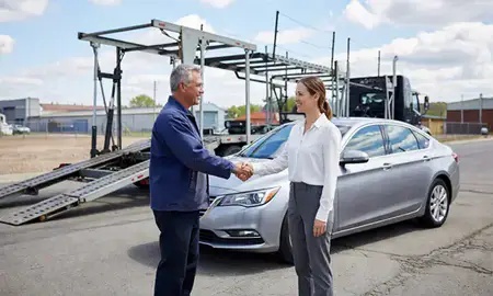 Vehicle owner beside their delivered car in Elizabeth, New Jersey, United States