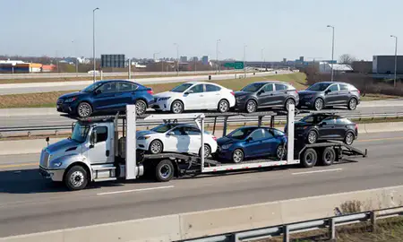 Multi-level car carrier on the highway to Fort Lee, New Jersey, United States