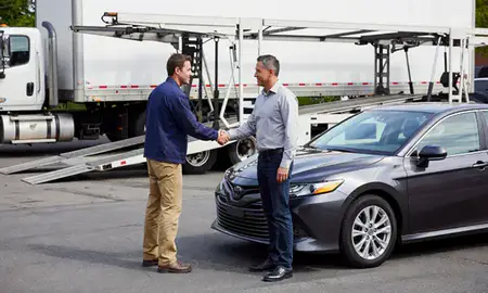 Vehicle owner beside their delivered car in Garfield, New Jersey, United States