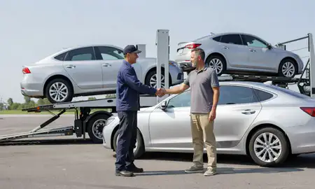 Vehicle owner beside their delivered car in Linden, New Jersey, United States