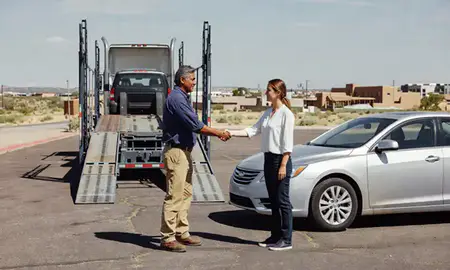 Vehicle owner beside their delivered car in Albuquerque, New Mexico, United States