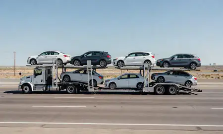 Multi-level car carrier on the highway to Anthony, New Mexico, United States