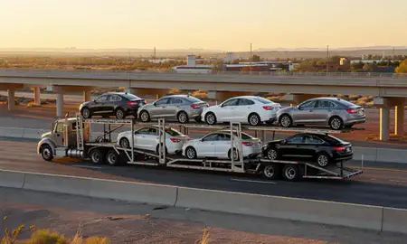 Car transporter with the Chaparral, New Mexico, United States skyline behind it