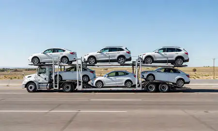Multi-level car carrier on the highway to Clovis, New Mexico, United States