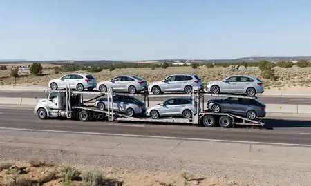 Multi-level car carrier on the highway to Corrales, New Mexico, United States