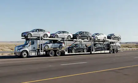 Multi-level car carrier on the highway to Deming, New Mexico, United States