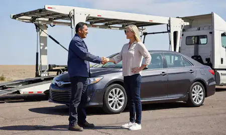 Vehicle owner beside their delivered car in Española, New Mexico, United States