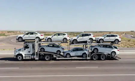 Multi-level car carrier on the highway to Gallup, New Mexico, United States