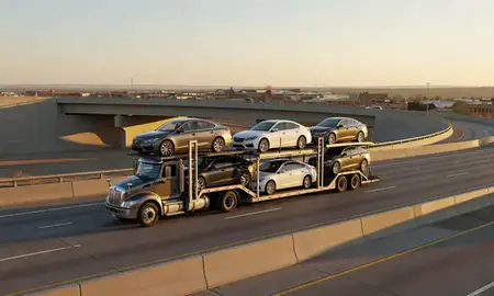Car transporter with the Grants, New Mexico, United States skyline behind it