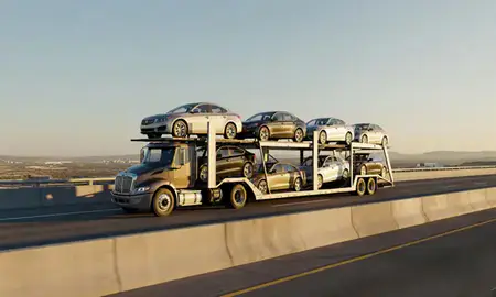 Car transporter with the Los Lunas, New Mexico, United States skyline behind it