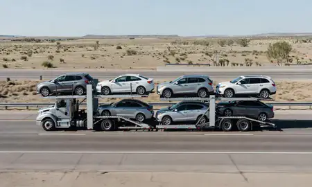 Multi-level car carrier on the highway to Lovington, New Mexico, United States