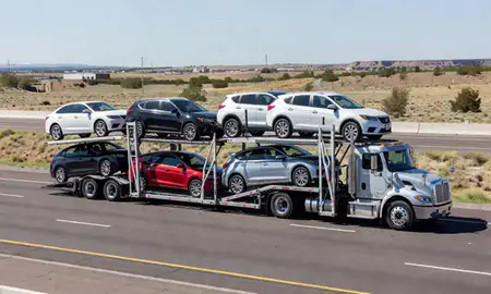 Multi-level car carrier on the highway to Rio Rancho, New Mexico, United States