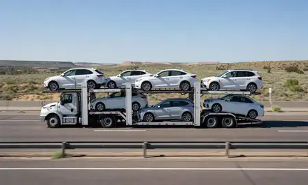 Multi-level car carrier on the highway to Santa Fe, New Mexico, United States