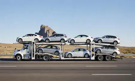 Multi-level car carrier on the highway to Shiprock, New Mexico, United States