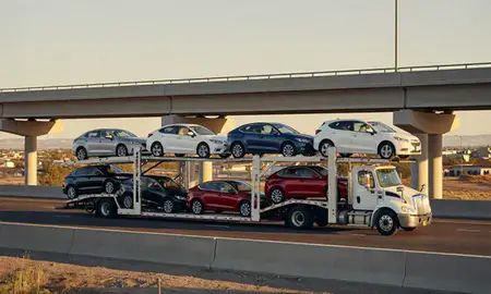 Car transporter with the Socorro, New Mexico, United States skyline behind it