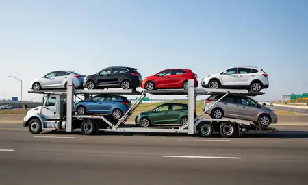 Multi-level car carrier on the highway to New York, United States