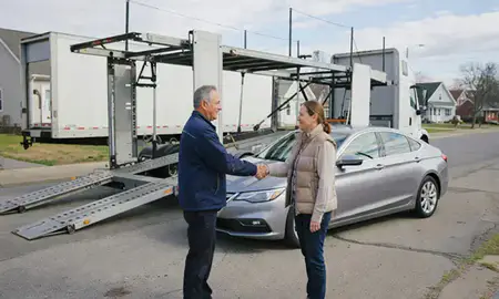 Vehicle owner beside their delivered car in Binghamton, New York, United States