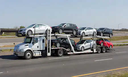 Multi-level car carrier on the highway to Coram, New York, United States