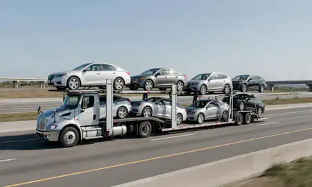 Multi-level car carrier on the highway to Elmont, New York, United States