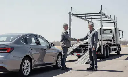 Vehicle owner beside their delivered car in Freeport, New York, United States