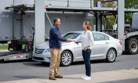 Vehicle owner beside their delivered car in Levittown, New York, United States