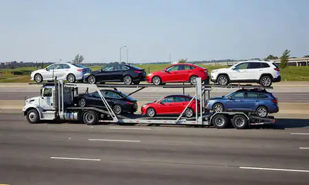 Multi-level car carrier on the highway to Queens, New York, United States