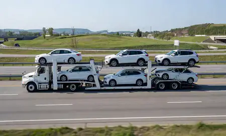 Multi-level car carrier on the highway to Utica, New York, United States