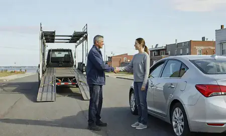 Vehicle owner beside their delivered car in Yonkers, New York, United States